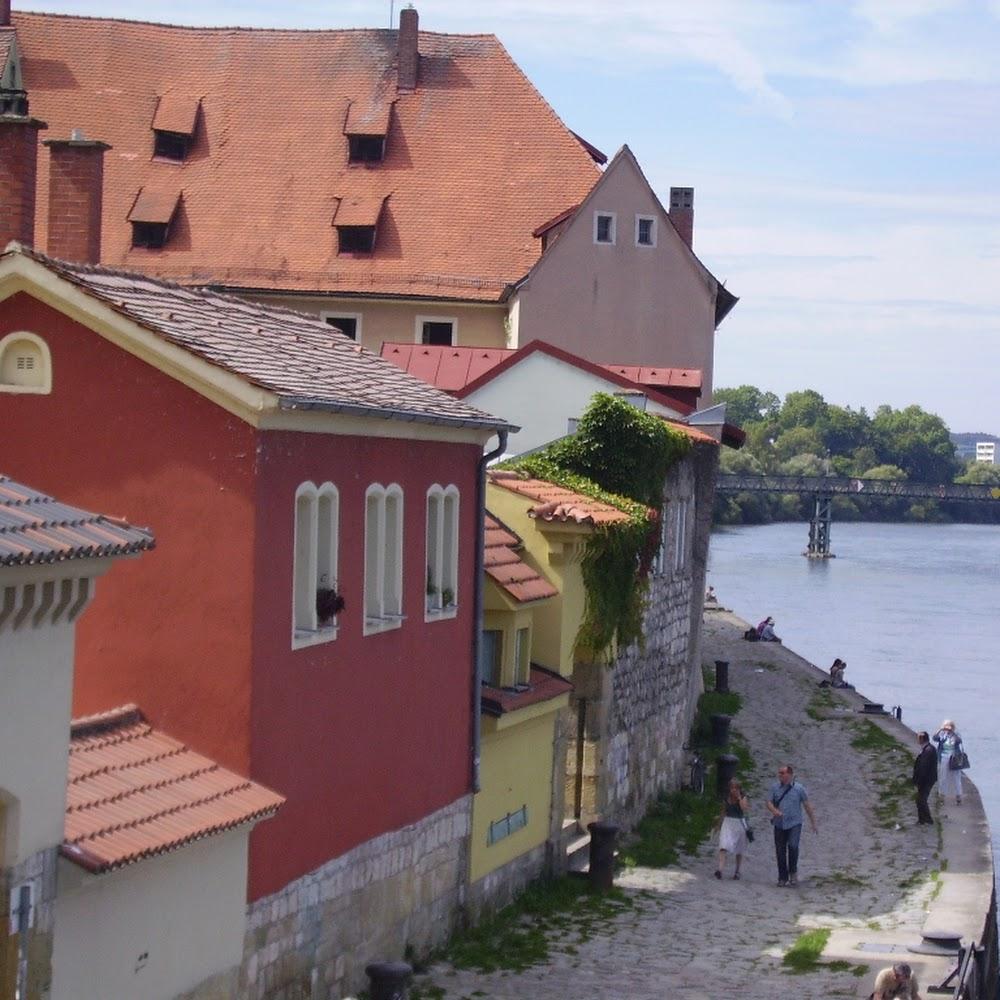 European architecture, red houses, cobblestone street, river, bridge.